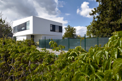 Výtvarný princíp fasády sa zakladá na kontraste čiernej a bielej. Čierne rámy okien na poschodí prepája hladký čierny keramický obklad.