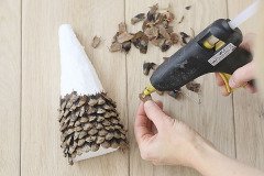 9. na kužeľ nalepte lupienky šišiek pomocou tavnej pištole, zospodu stromčeka nalepte kmeň